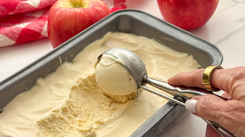 hand scooping ice cream from loaf pan