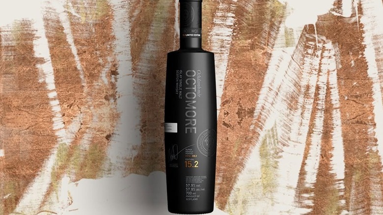 A stylized product shot of a bottle of Bruichladdich Octomore against a rustic artistic background