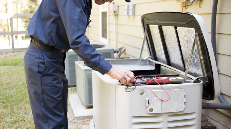 A person inspecting home generator