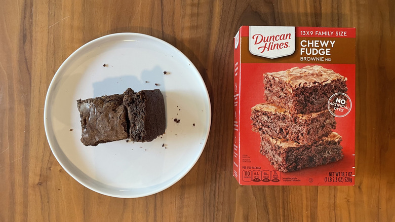 Chewy fudge brownie mix box and baked brownies on a plate
