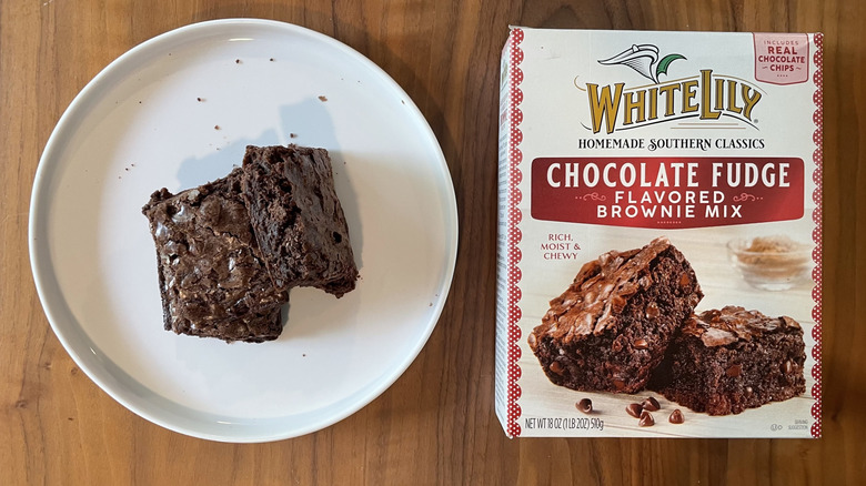 White Lily Chocolate Fudge brownie mix box and baked brownies on a plate