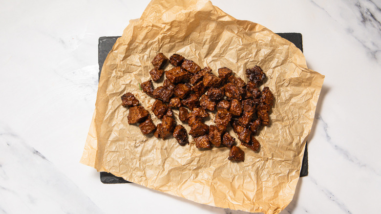 Steak bites on tray with parchment paper