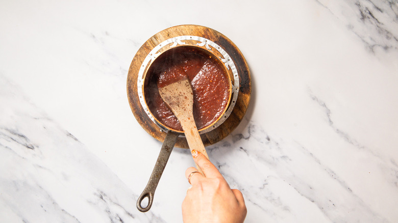 Stirring sauce in saucepan