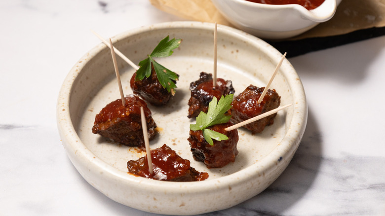 Steak bites in small plate with toothpicks