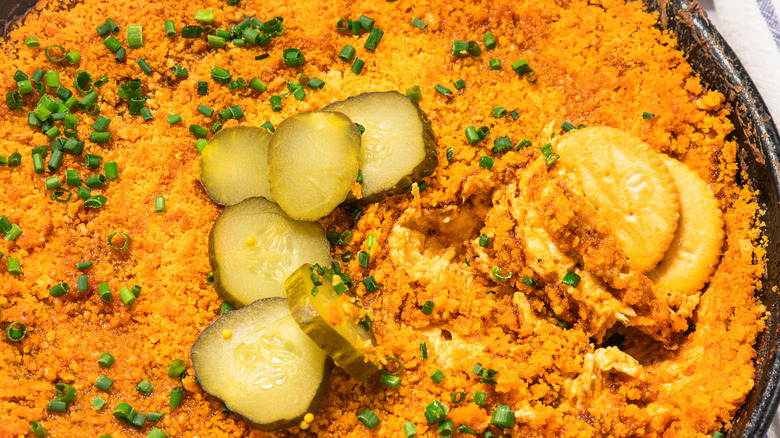 Nashville hot chicken dip with crackers dipped inside