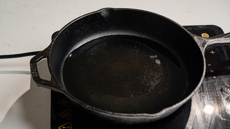 heating oil in a cast iron skillet