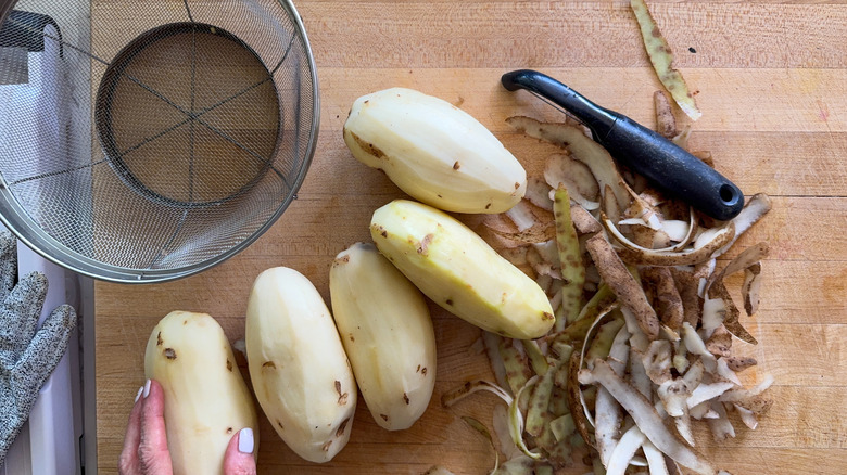 Russet potatoes peeled on board