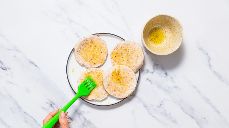 brushing sausage patties with oil