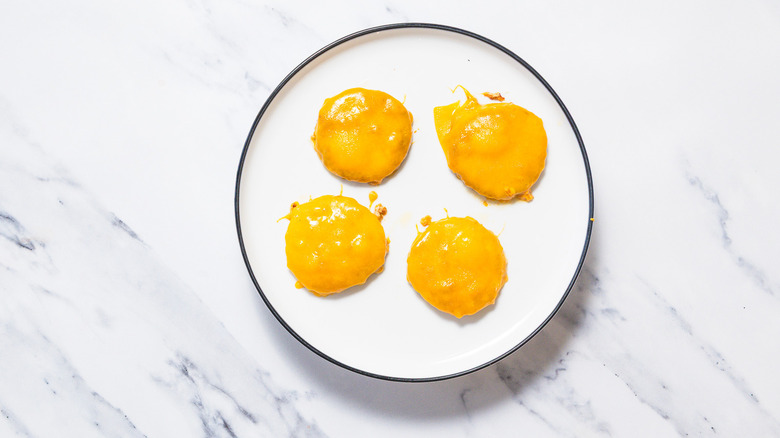 cooked patties with melted cheese on plate