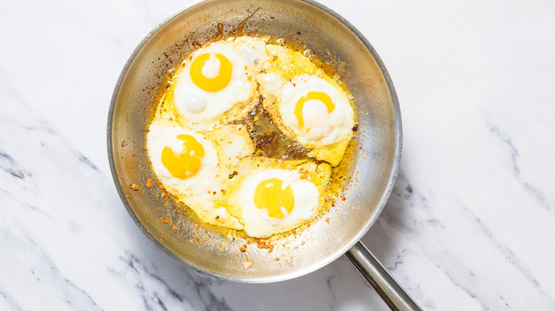 cooked sunny side up eggs on pan