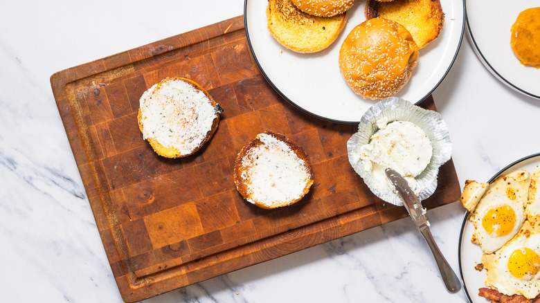 spreading buns with Boursin cheese