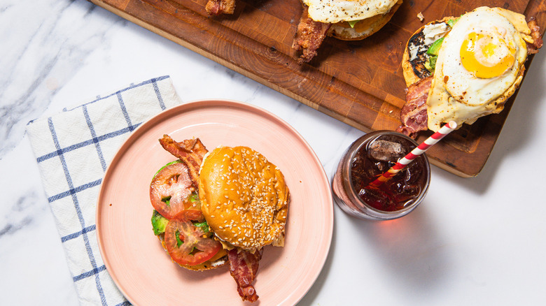 Sausage breakfast burger on plate with coke