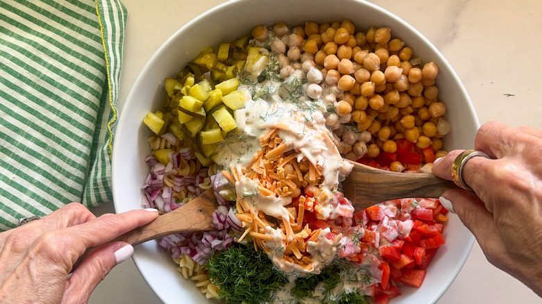 hands tossing salad