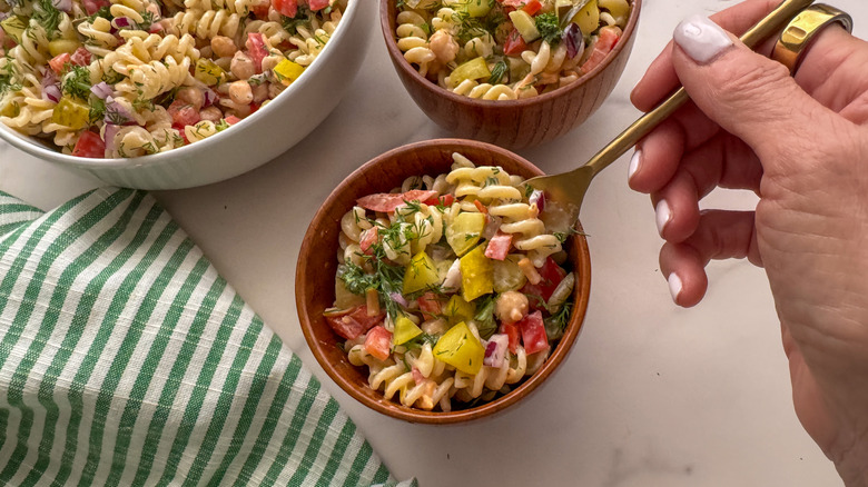 hand with fork in bowl