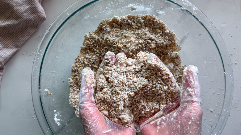 hands showing crumb mixture