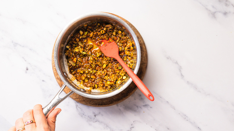 Pistachios in caramel saucepan