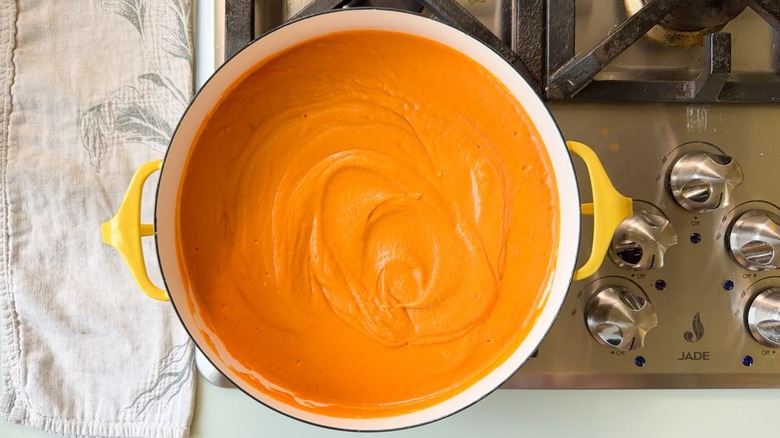 Pureed white bean tomato soup in Dutch oven on stovetop