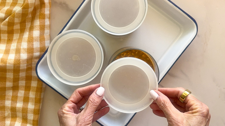 hands putting lid on jar