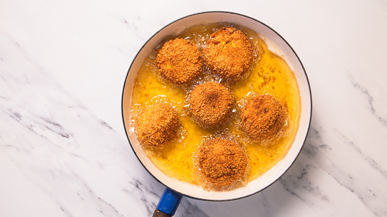 Frying arancini in oil