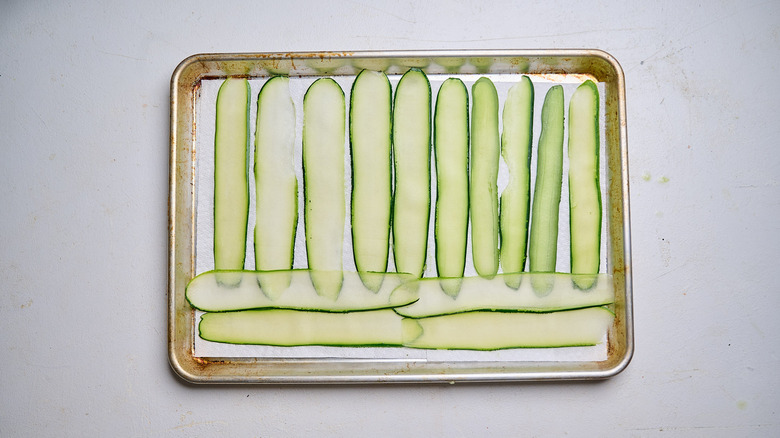 salted zucchini on paper-towel lined sheet tray
