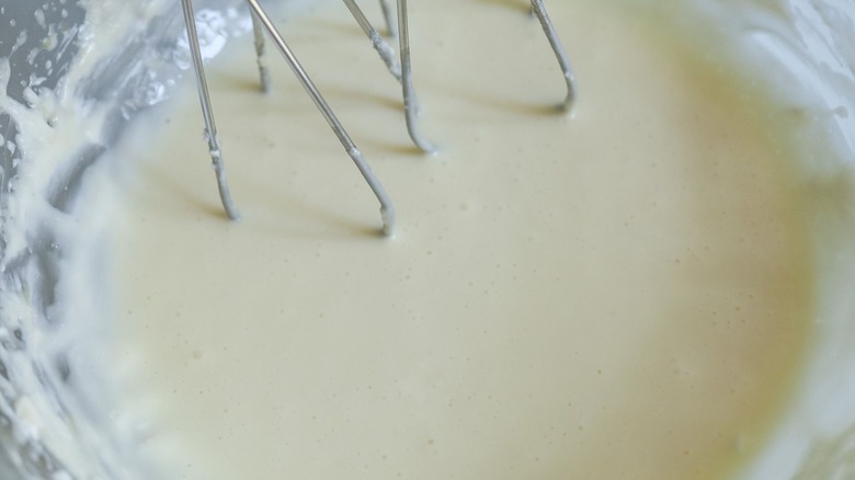 Cheesecake batter in bowl with mixers